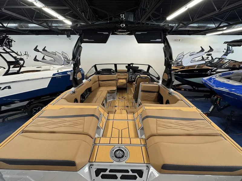 Slide: The Image of 2025 Supra SV 400 boat interior with tan seating and modern design in showroom. - 7
