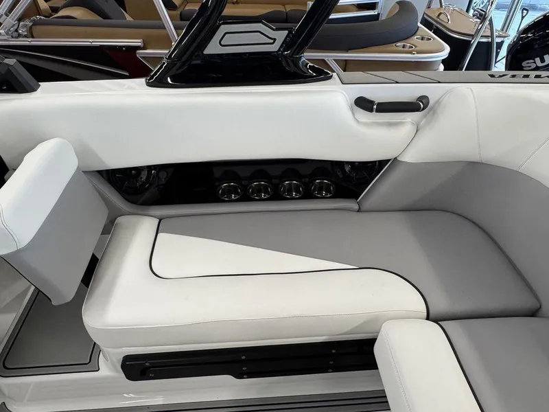Slide: The Image of 2025 Moomba Craz boat interior with white and gray seating, cup holders, and sleek design. - 10