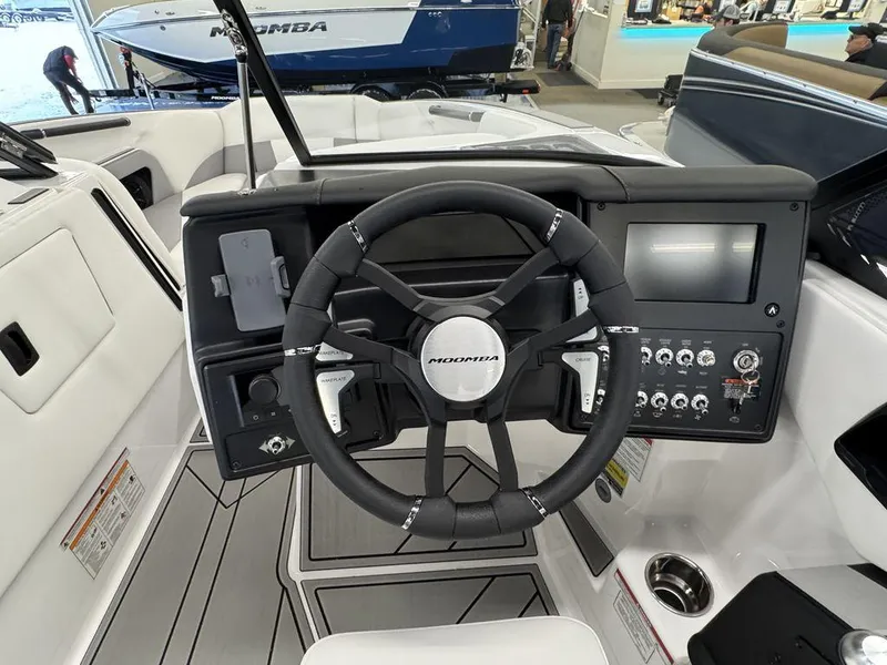 Slide: The Image of 2025 Moomba Craz boat dashboard with steering wheel and control panel. - 12