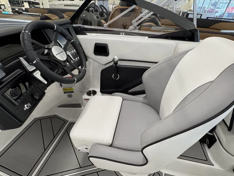 Slide: The Image of 2025 Moomba Craz boat interior with steering wheel and captain's seat. - 13