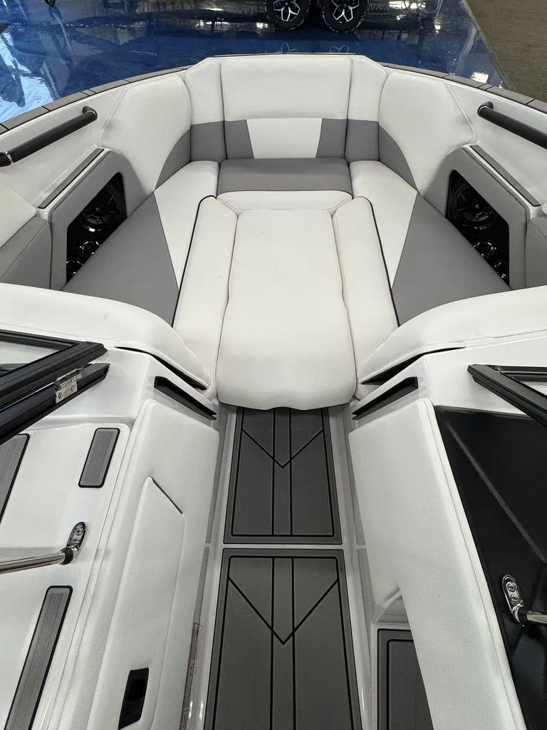 Slide: The Image of 2025 Moomba Craz boat interior with sleek white and gray seating and modern design. - 14