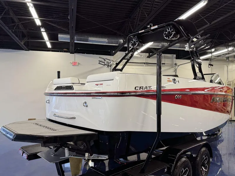 Slide: The Image of 2025 Moomba Craz boat in showroom, featuring sleek design and vibrant red accents. - 2
