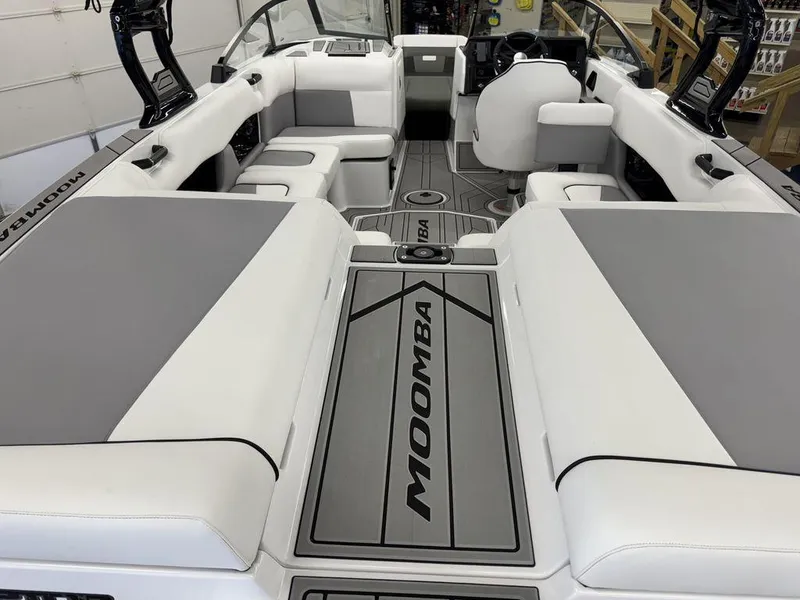 Slide: The Image of 2025 Moomba Craz boat interior with gray and white seating, sleek design, and modern dashboard. - 4
