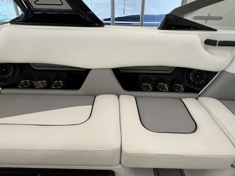 Slide: The Image of 2025 Moomba Craz boat interior with white and gray seating, cup holders, and speakers. - 6