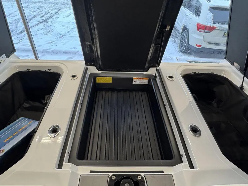 Slide: The Image of 2025 Moomba Craz boat storage compartments with open lids, showcasing interior space. - 8
