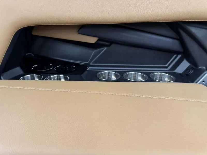 Slide: The Image of 2025 Supra SL 450 interior with beige leather and cup holders. - 18