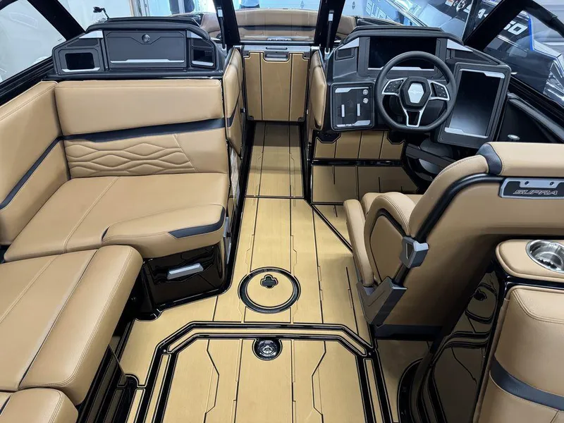 Slide: The Image of Luxurious interior of 2025 Supra SL 450 boat with tan leather seating and modern dashboard. - 19