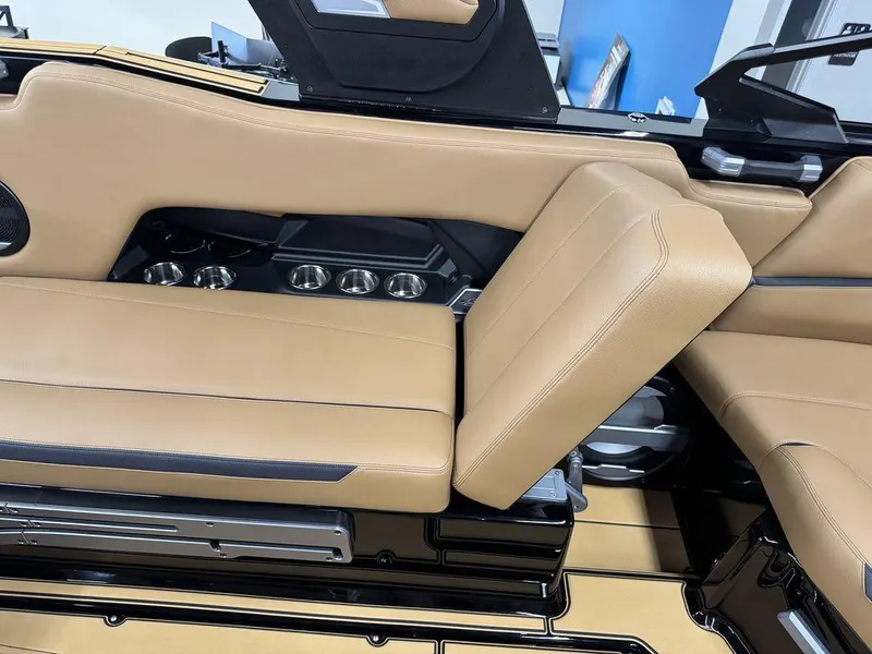 Slide: The Image of 2025 Supra SL 450 interior with tan leather seats and cup holders. - 20