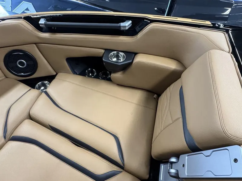 Slide: The Image of 2025 Supra SL 450 interior with tan leather seats and built-in speaker system. - 26