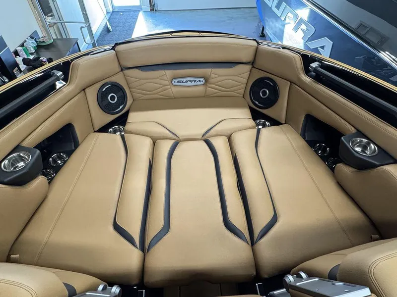 Slide: The Image of Luxurious interior of 2025 Supra SL 450 boat with tan upholstery and speakers. - 30