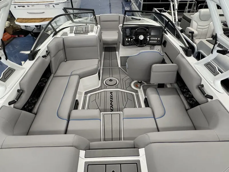 Slide: The Image of 2025 Moomba Mondo boat interior with gray seating and modern dashboard design. - 11