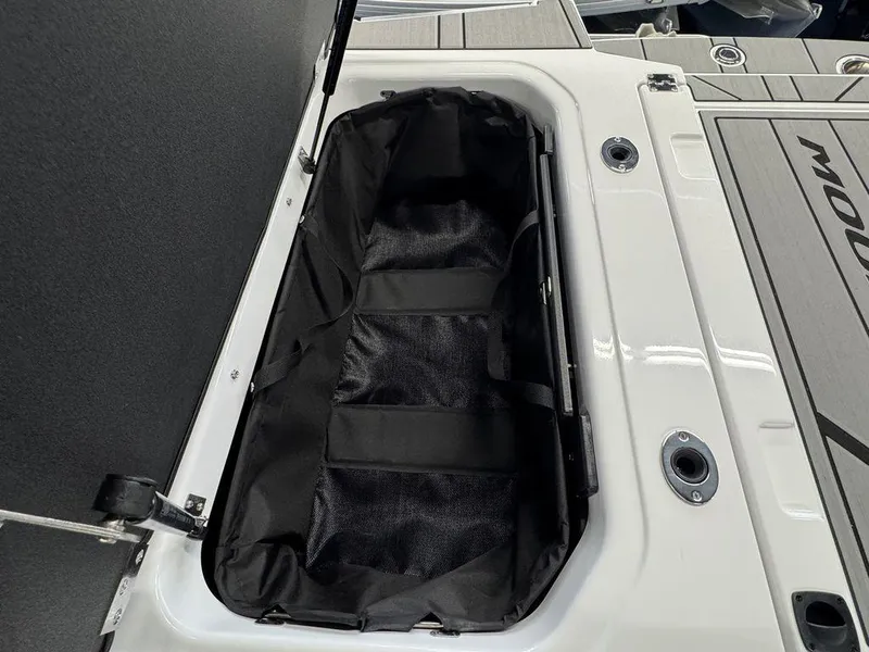 Slide: The Image of 2025 Moomba Mondo boat storage compartment with open lid, showcasing interior space. - 13
