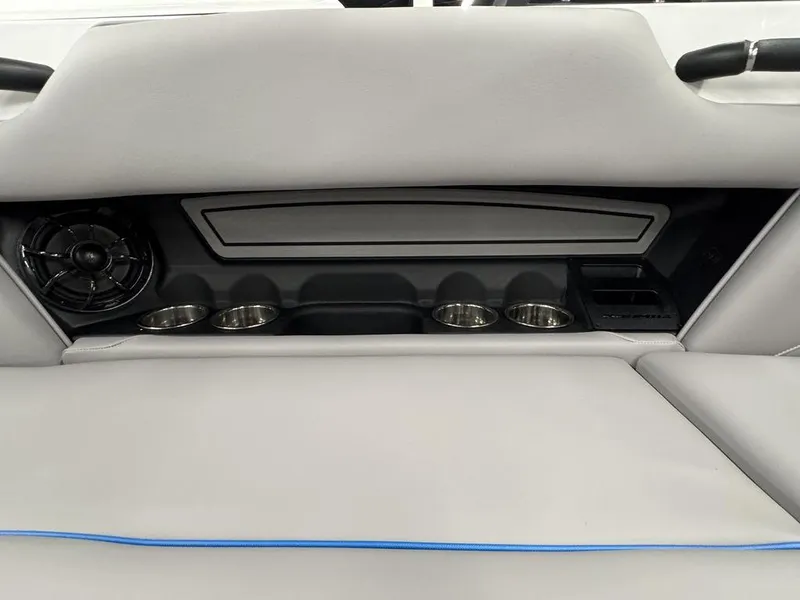 Slide: The Image of 2025 Moomba Mondo interior with cup holders and speaker, featuring sleek design elements. - 14