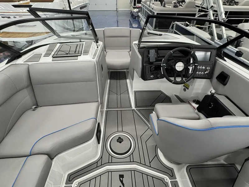 Slide: The Image of 2025 Moomba Mondo boat interior with modern dashboard and gray seating. - 15