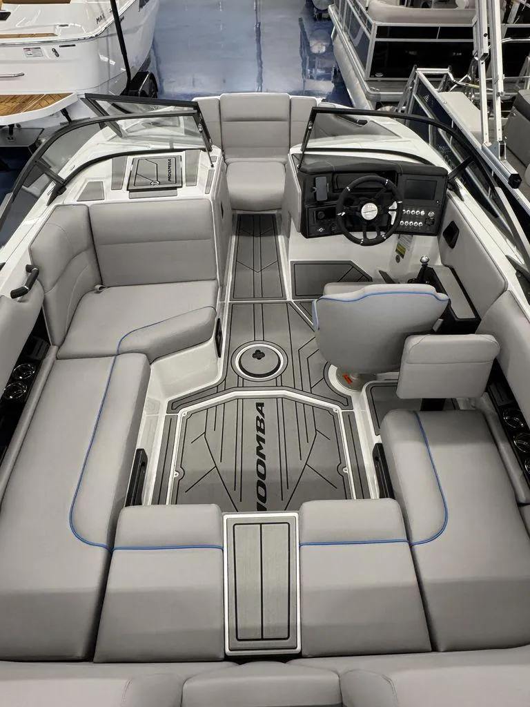 Slide: The Image of 2025 Moomba Mondo boat interior with sleek gray seating and modern dashboard design. - 19