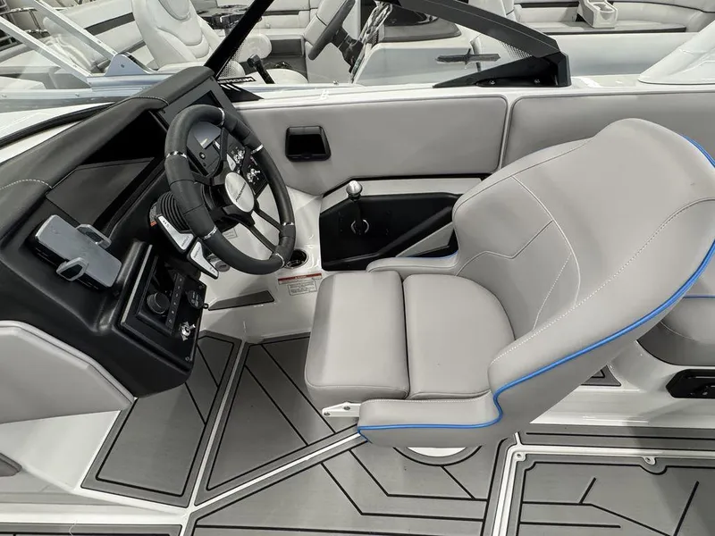 Slide: The Image of 2025 Moomba Mondo boat interior with sleek steering wheel and modern seating design. - 7