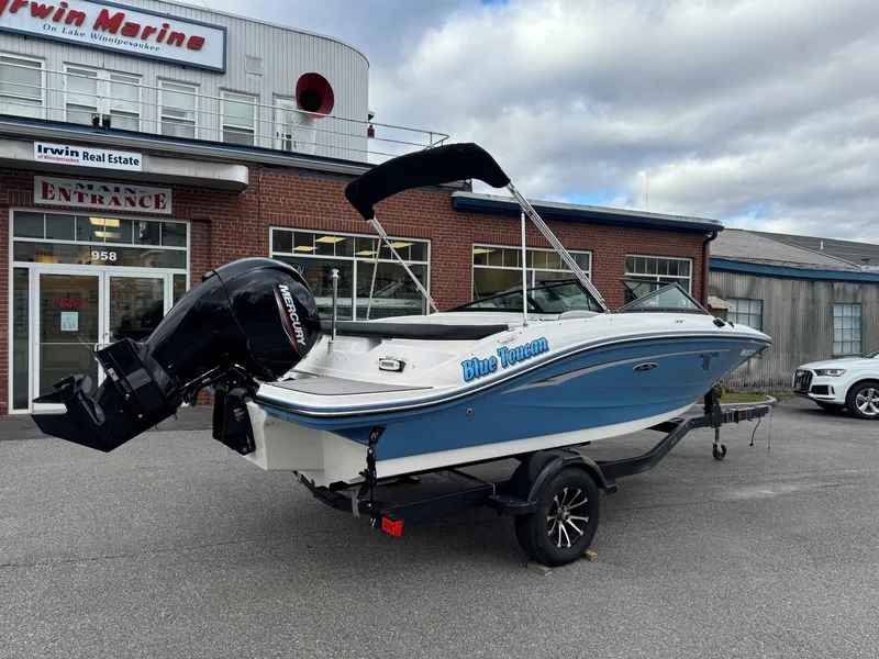 Slide: The Image of 2023 Sea Ray 190SPXO boat, blue and white, parked outside Irwin Marine. - 2