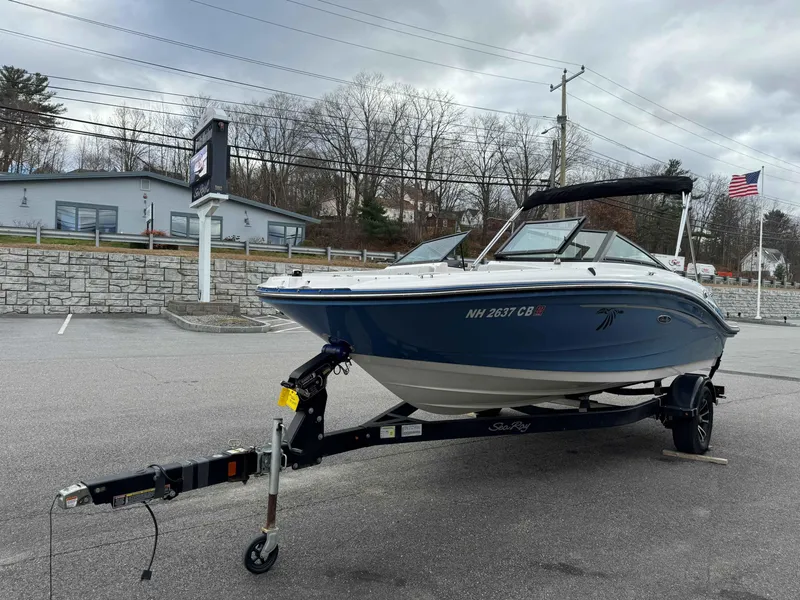 Slide: The Image of 2023 Sea Ray 190SPXO boat on trailer in parking lot, overcast sky. - 4