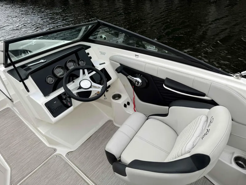 Slide: The Image of 2023 Sea Ray 190SPXO boat interior with steering wheel and dashboard controls. - 8