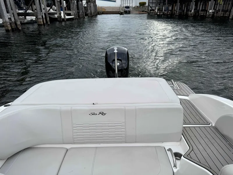 Slide: The Image of 2023 Sea Ray 190SPXO boat stern view with outboard motor on water. - 9