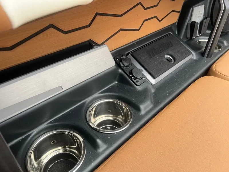 Slide: The Image of 2025 Malibu 23 MXZ interior with cup holders and sleek design. - 10