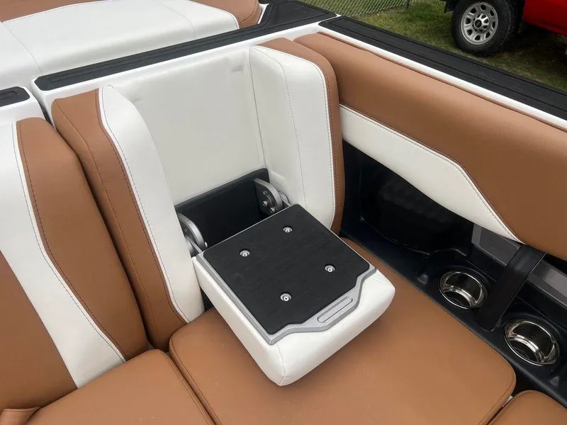 Slide: The Image of 2025 Malibu 23 MXZ boat interior with brown and white leather seating. - 15