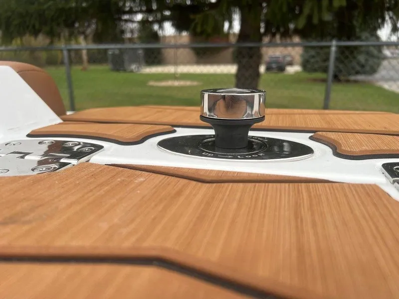 Slide: The Image of 2025 Malibu 23 MXZ boat detail with teak deck and chrome hardware. - 17