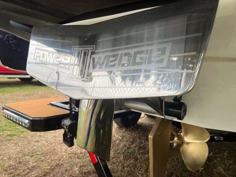 Slide: The Image of 2025 Malibu 23 MXZ Power Wedge III detail with propeller and trailer. - 22