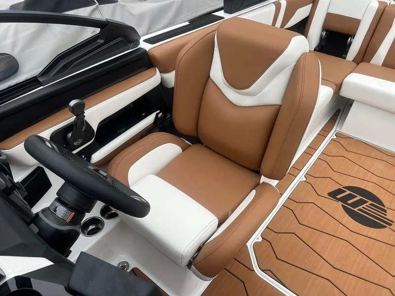 Slide: The Image of 2025 Malibu 23 MXZ boat interior with brown and white seating, sleek design. - 6
