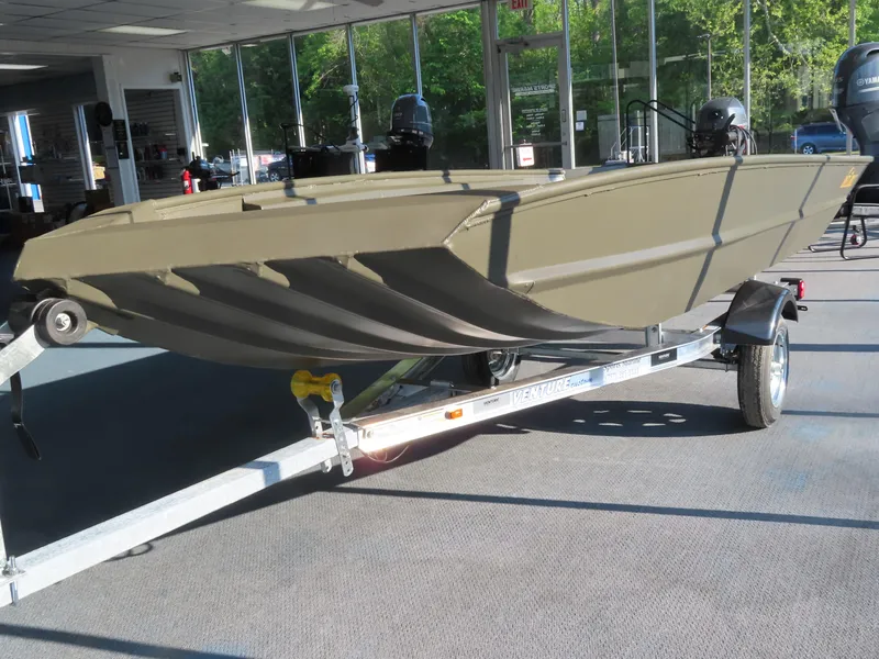 Slide: The Image of 2025 WeldBilt 1448V boat on trailer in showroom, side view. - 1