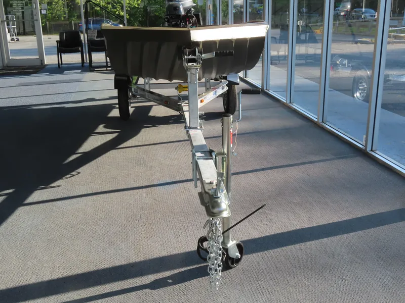 Slide: The Image of 2025 WeldBilt 1448V boat on trailer in showroom with sunlight. - 2