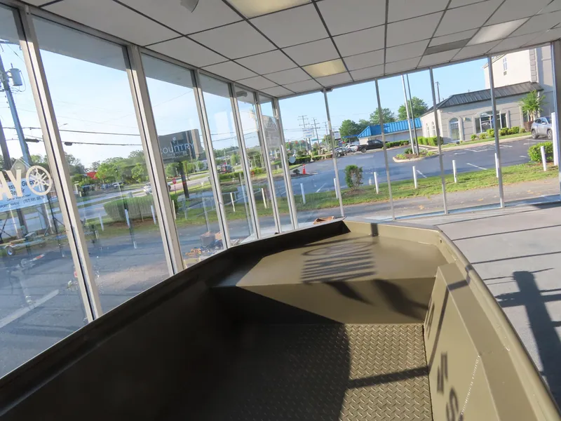 Slide: The Image of 2025 WeldBilt 1448V boat displayed in a showroom with large windows. - 3