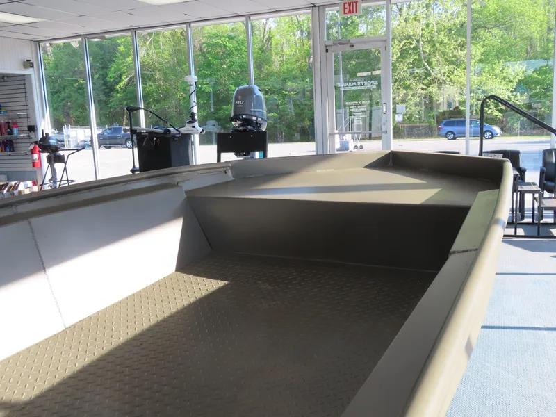 Slide: The Image of 2025 WeldBilt 1448V boat interior in showroom with outboard motor display. - 4