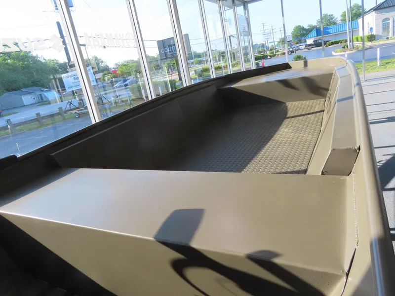 Slide: The Image of 2025 WeldBilt 1448V boat interior, showcasing spacious, durable design in showroom setting. - 5