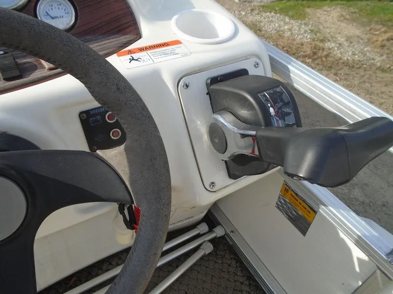 Slide: The Image of Close-up of 2005 Lowe Trinidad 200 boat steering wheel and throttle control. - 16