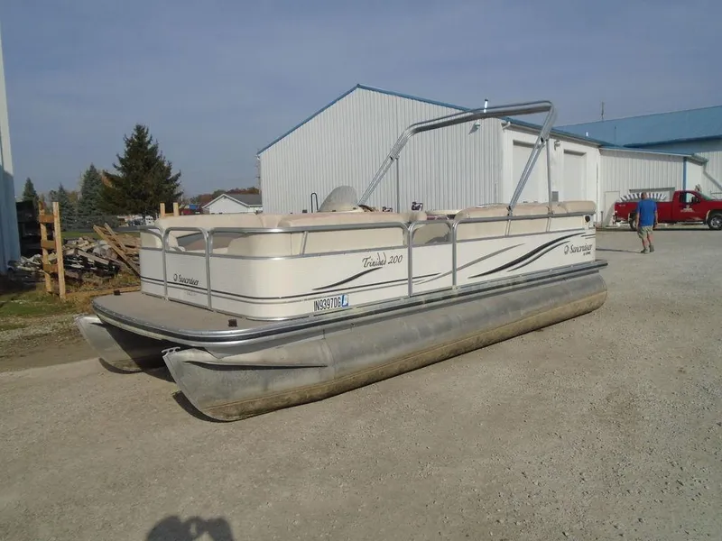 Slide: The Image of 2005 Lowe Trinidad 200 pontoon boat parked on gravel near buildings. - 20
