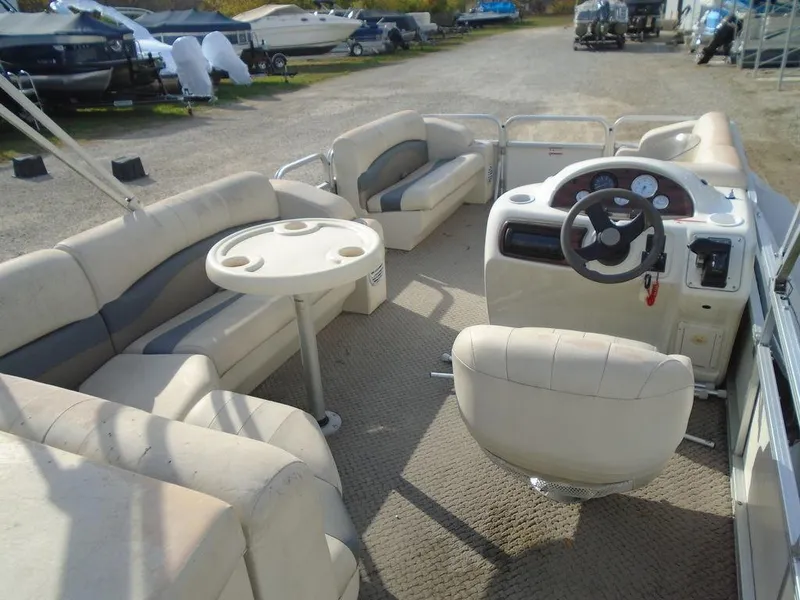 Slide: The Image of 2005 Lowe Trinidad 200 pontoon boat interior with seating and steering console. - 4