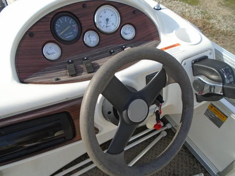 Slide: The Image of Steering wheel and dashboard of 2005 Lowe Trinidad 200 boat. - 6