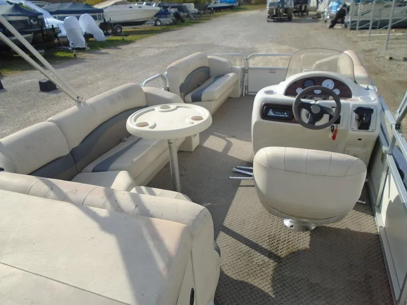Slide: The Image of 2005 Lowe Trinidad 200 pontoon boat interior with seating and steering console. - 7