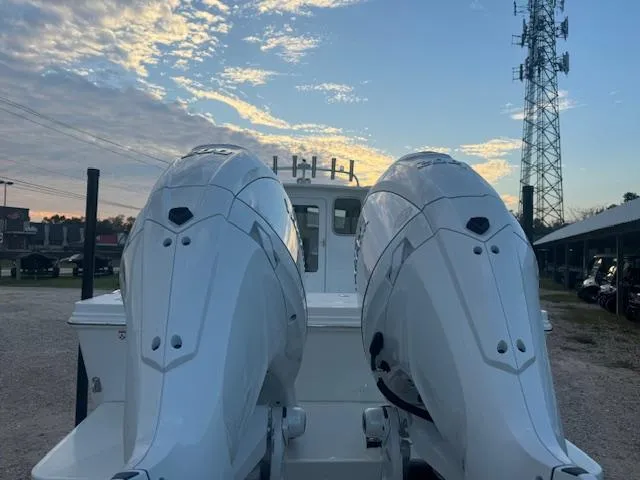 Slide: The Image of 2025 Parker 2420 Sport Cabin with dual engines at sunset. - 20