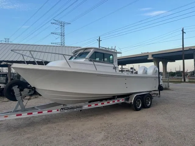 Slide: The Image of 2025 Parker 2420 Sport Cabin boat on trailer, parked outdoors. - 4