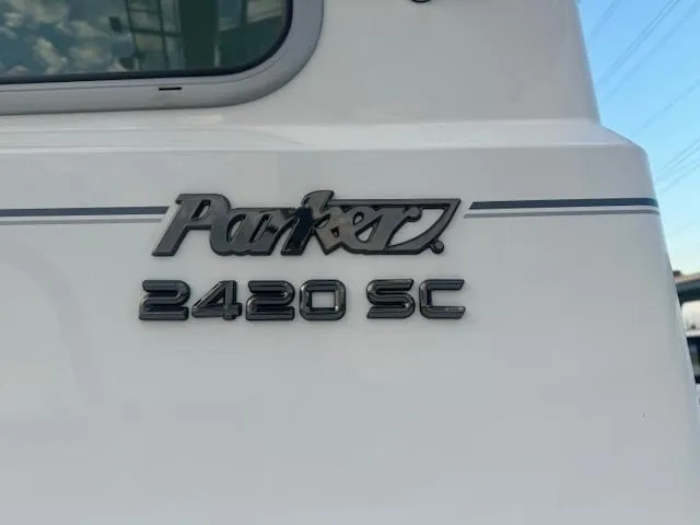 Slide: The Image of Parker 2420 Sport Cabin 2025 boat logo on white surface. - 5