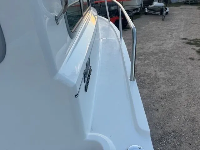 Slide: The Image of 2025 Parker 2420 Sport Cabin boat side view with railing. - 6