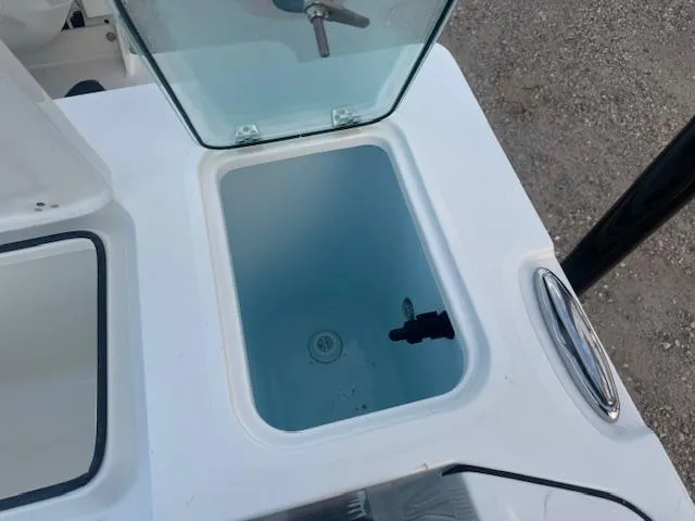 Slide: The Image of Parker 2420 Sport Cabin 2025 boat livewell with open lid, showcasing interior. - 8