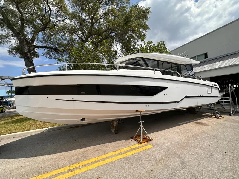 The Image of 2023 Wellcraft 355 boat on display outdoors, sleek design, white hull. - 0