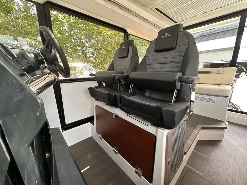 Slide: The Image of Interior of 2023 Wellcraft 355 boat with modern helm and seating. - 13