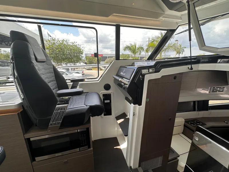 Slide: The Image of Interior of 2023 Wellcraft 355 boat, featuring modern helm and seating area. - 14