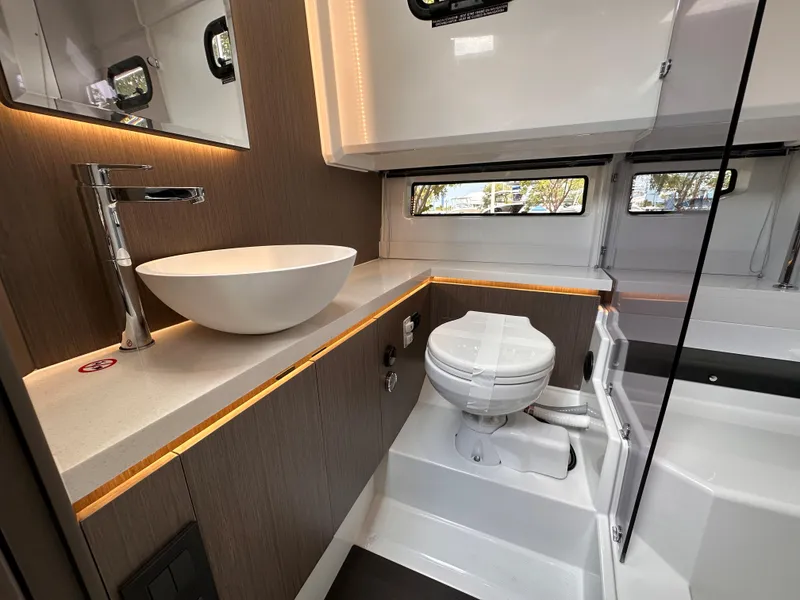 Slide: The Image of Modern bathroom interior of 2023 Wellcraft 355 boat, featuring sleek design and compact layout. - 17