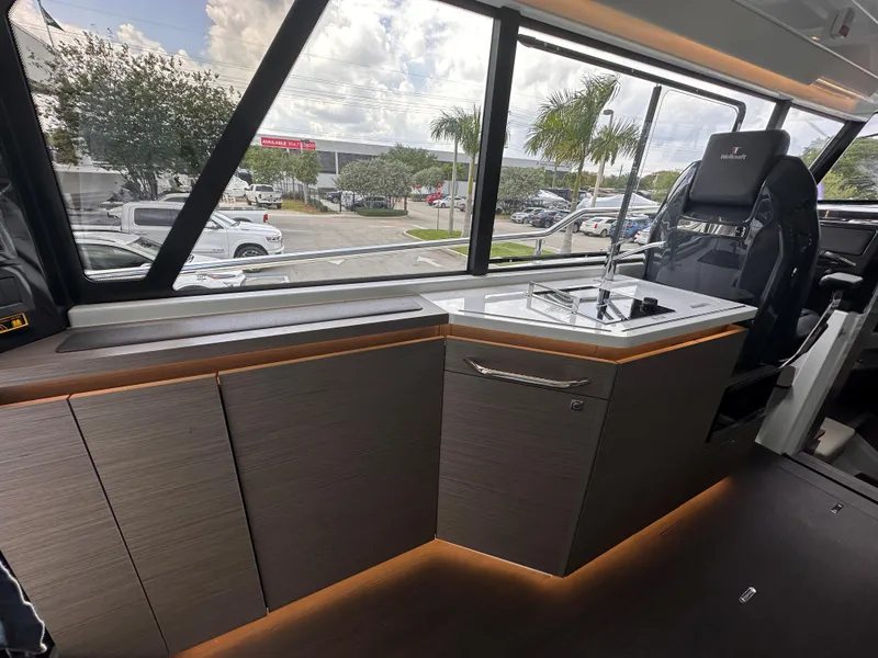 Slide: The Image of 2023 Wellcraft 355 boat interior with modern seating and panoramic windows. - 9