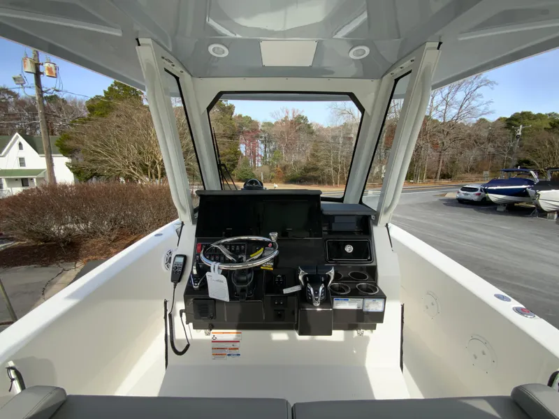 Slide: The Image of 2025 Pursuit S 288 Sport boat cockpit with modern controls and steering wheel. - 12